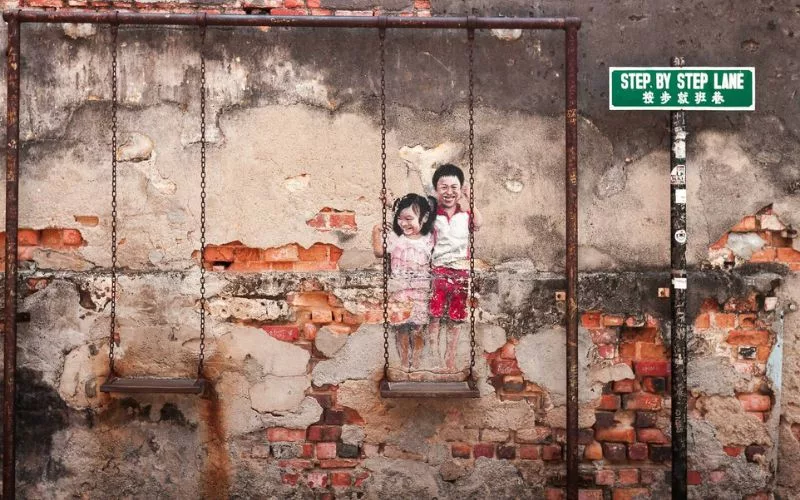 Penang street art - girl and boy on swing - gat lebuh chulia georgetown penang