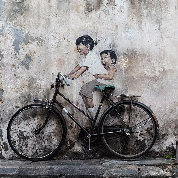 children on a bike street art Penang